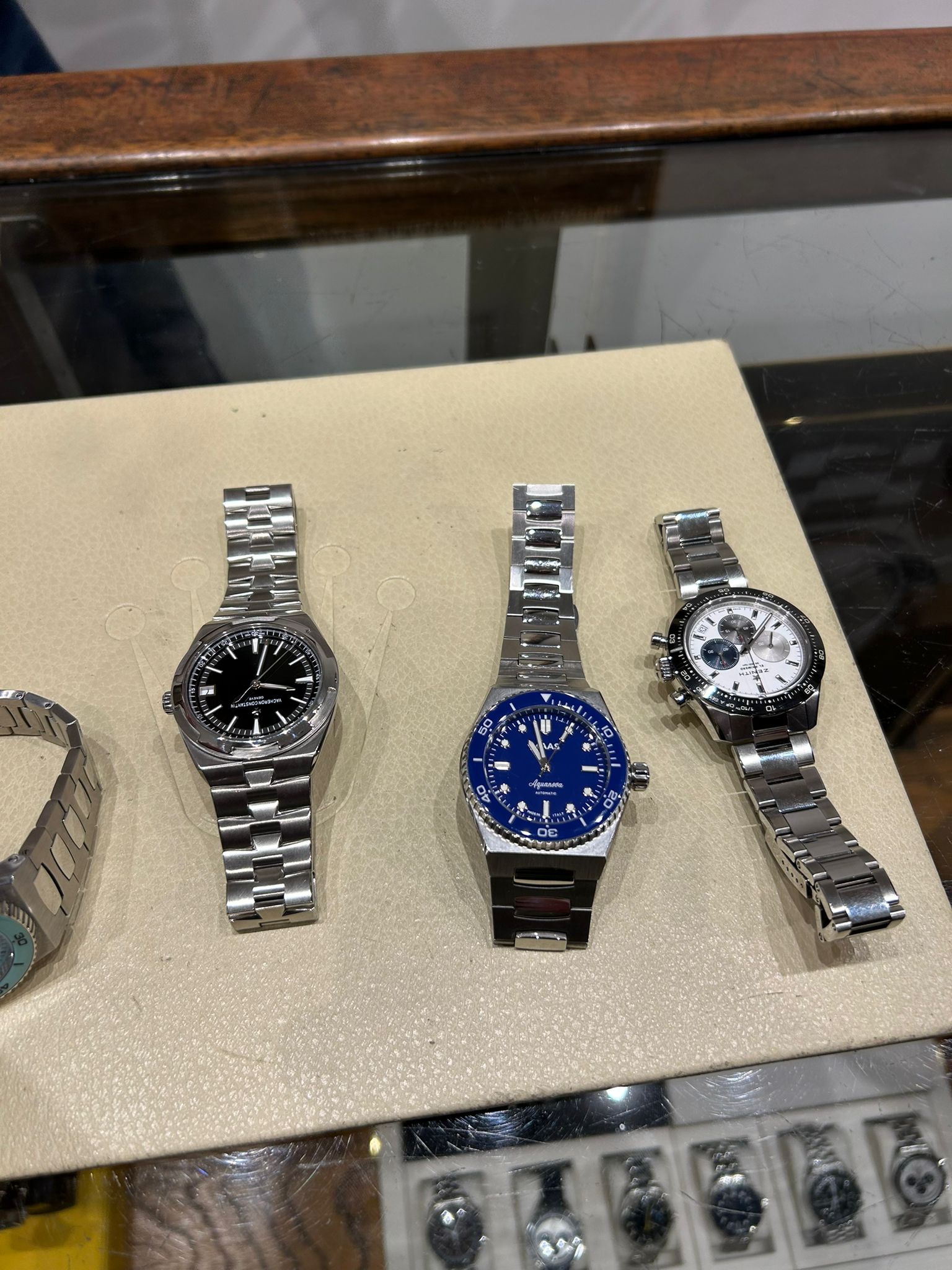 Three watches on a display with a blurred background
